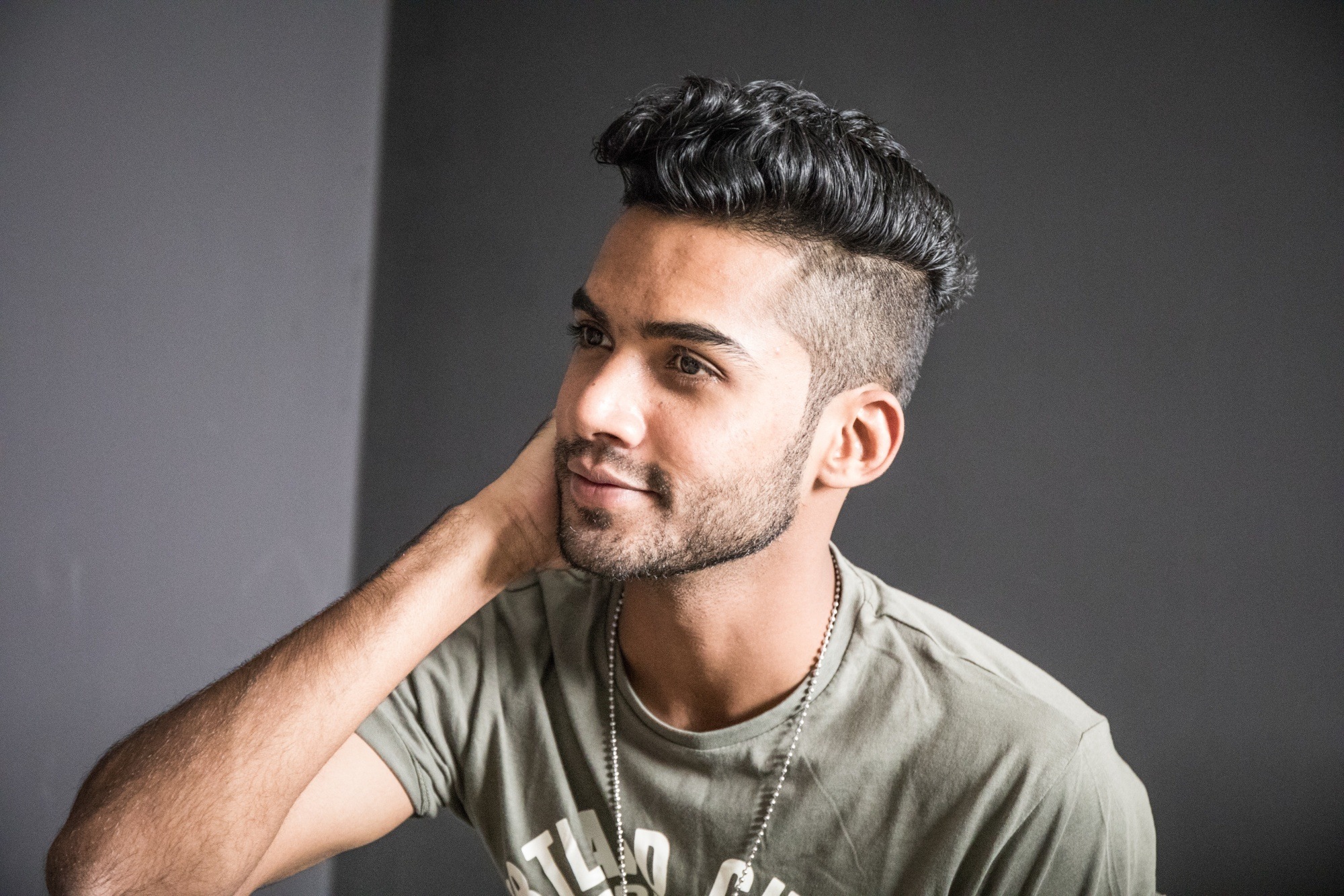 Haircuts for men with wavy hair: Asian man with wavy hair and faded haircut