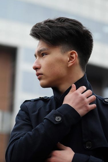Men's styling products: Asian man with short thick hair wearing a black jacket
