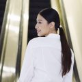 Asian woman with a low pony hairstyle