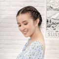 Asian woman with milkmaid braid for short hair wearing a light blue dress