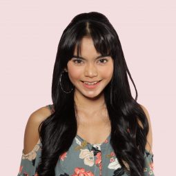 Asian woman with bangs and half updo hairstyle for heart-shaped faces