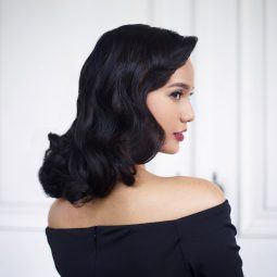 Vintage hairstyles: Asian woman with pinned curls hairstyle wearing an off-shoulder dress