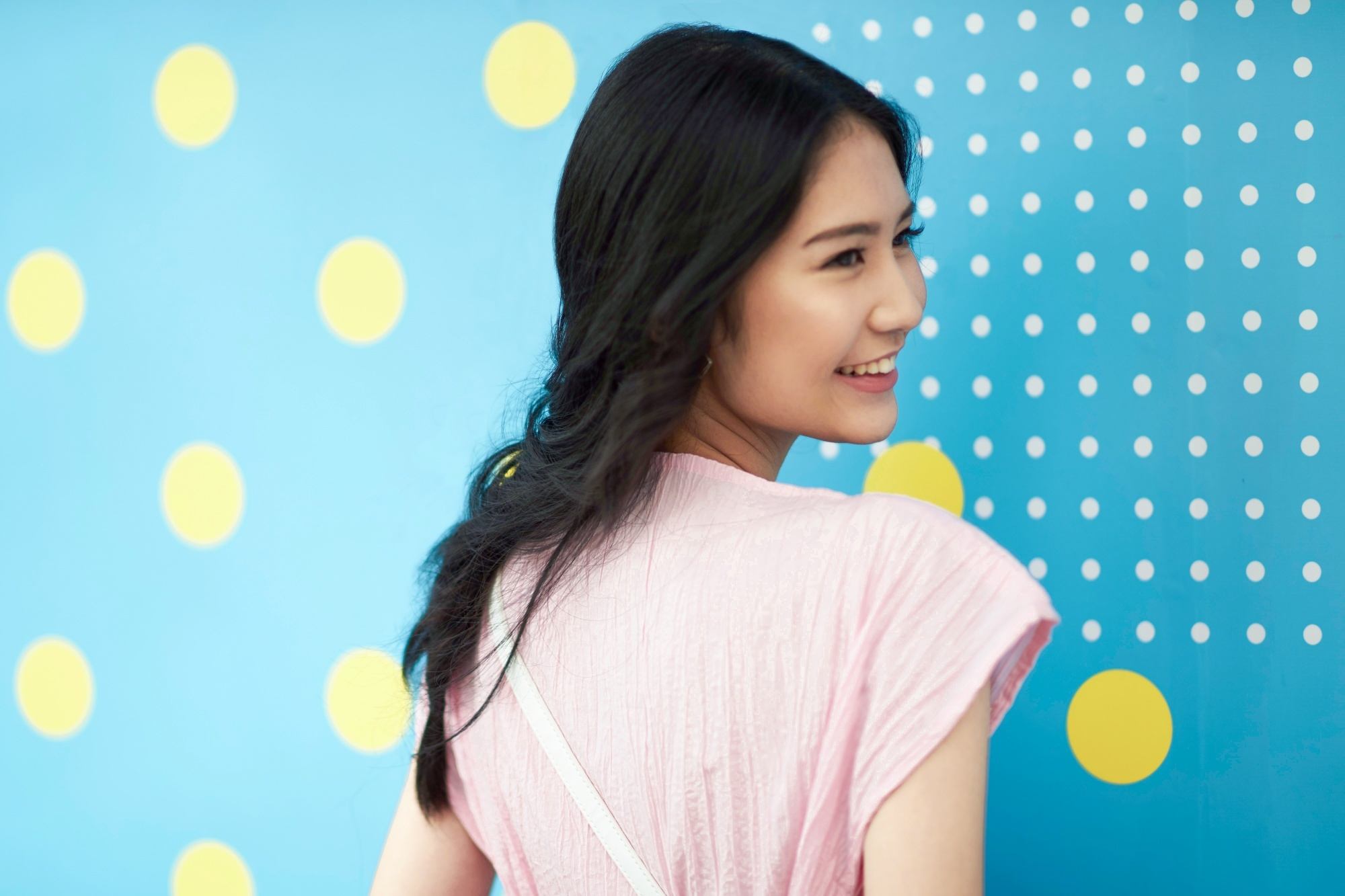 Asian woman with fishtail braid smiling