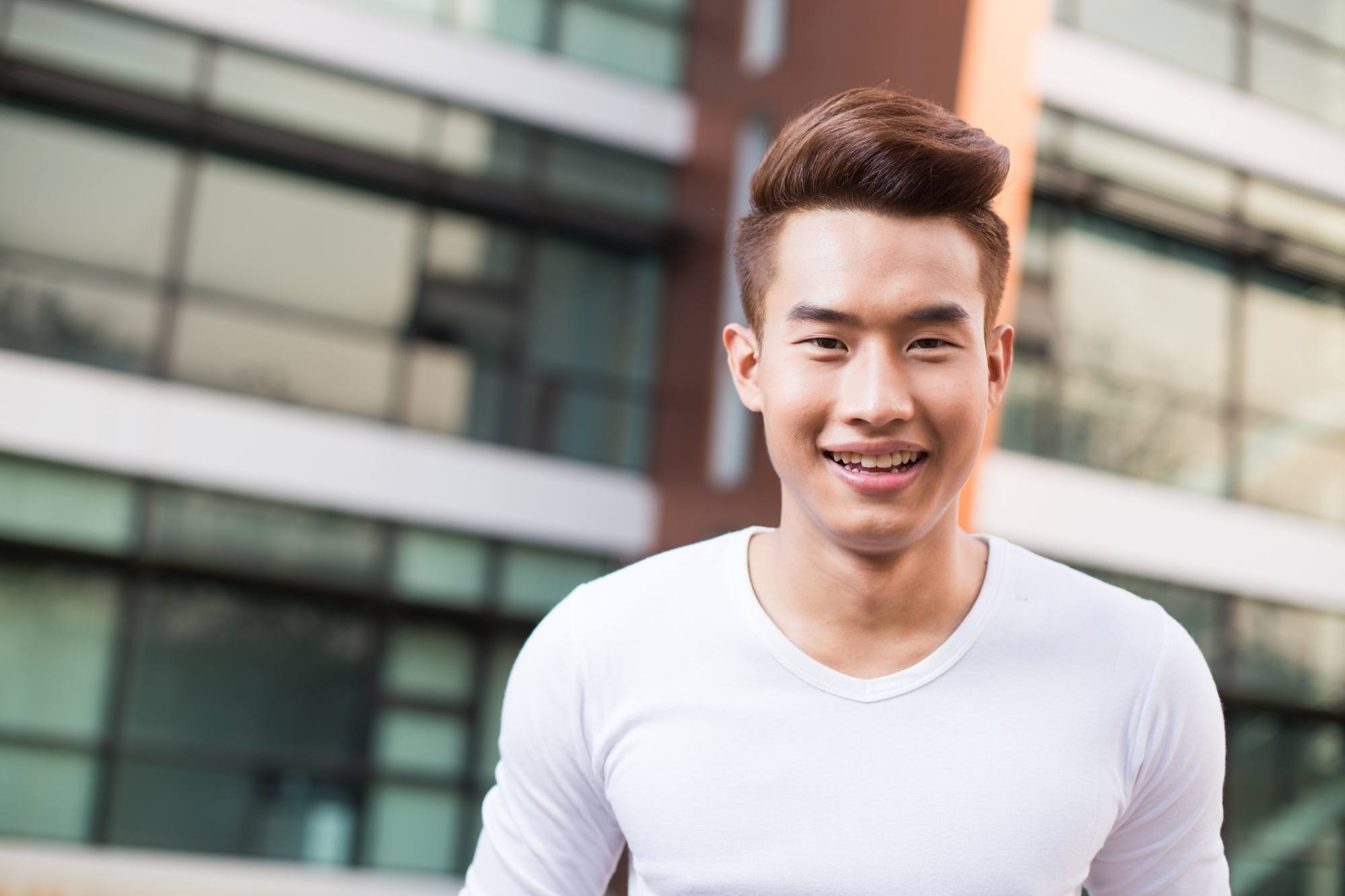 Asian with a disconnected hairstyle wearing a white shirt