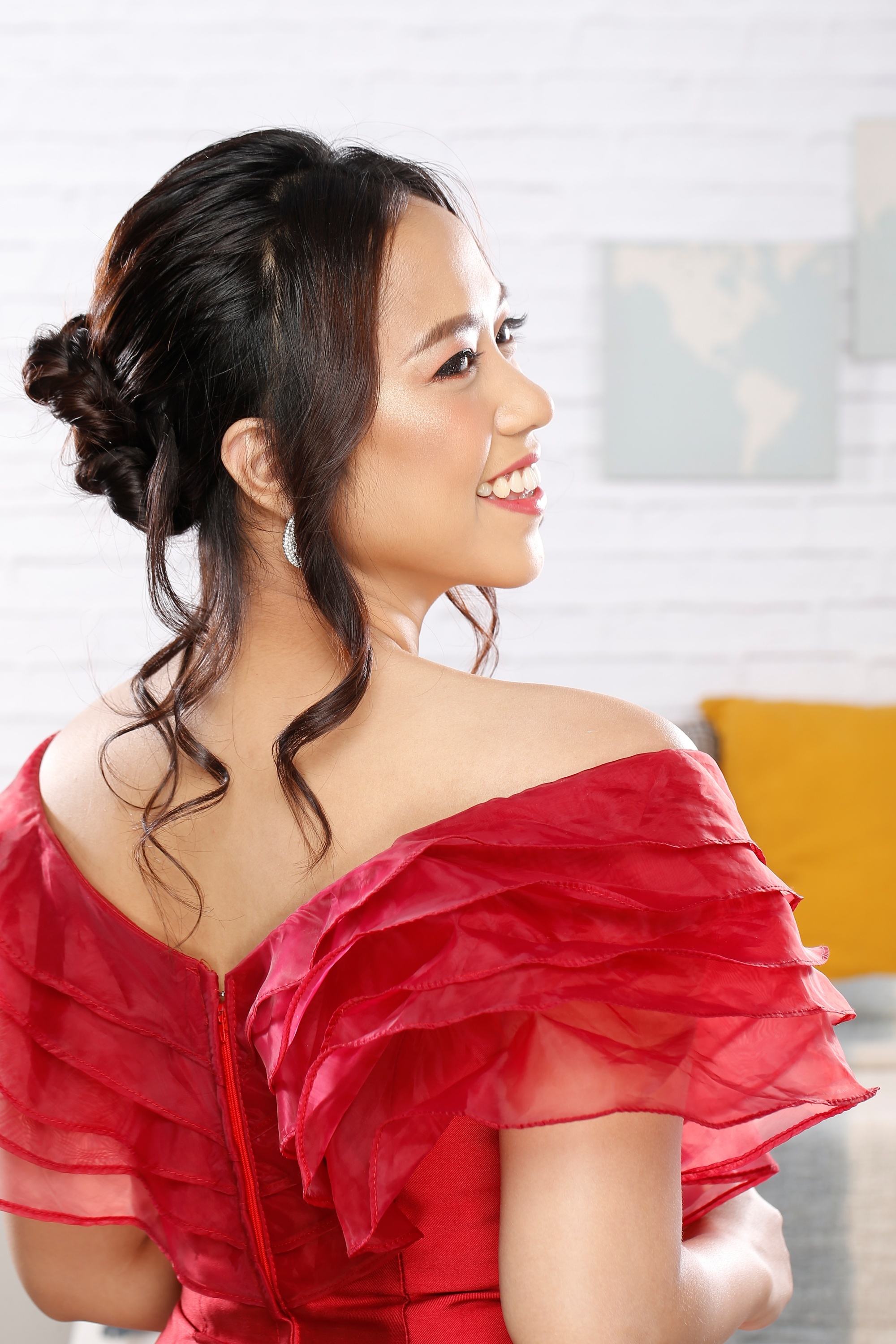 Asian woman with an updo with loose curls as her prom hairstyle