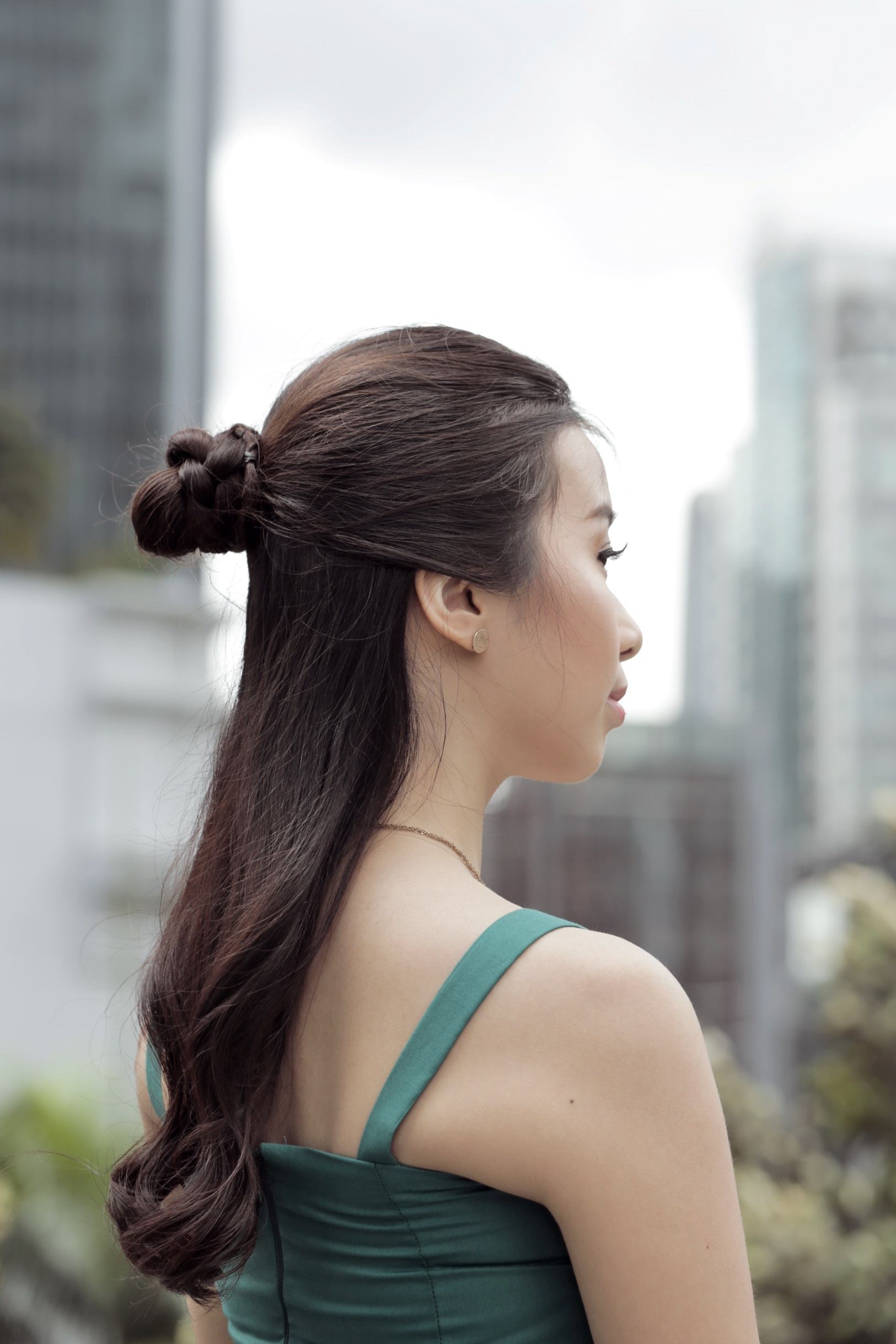 Asian woman with a half-up bun hairstyle for prom