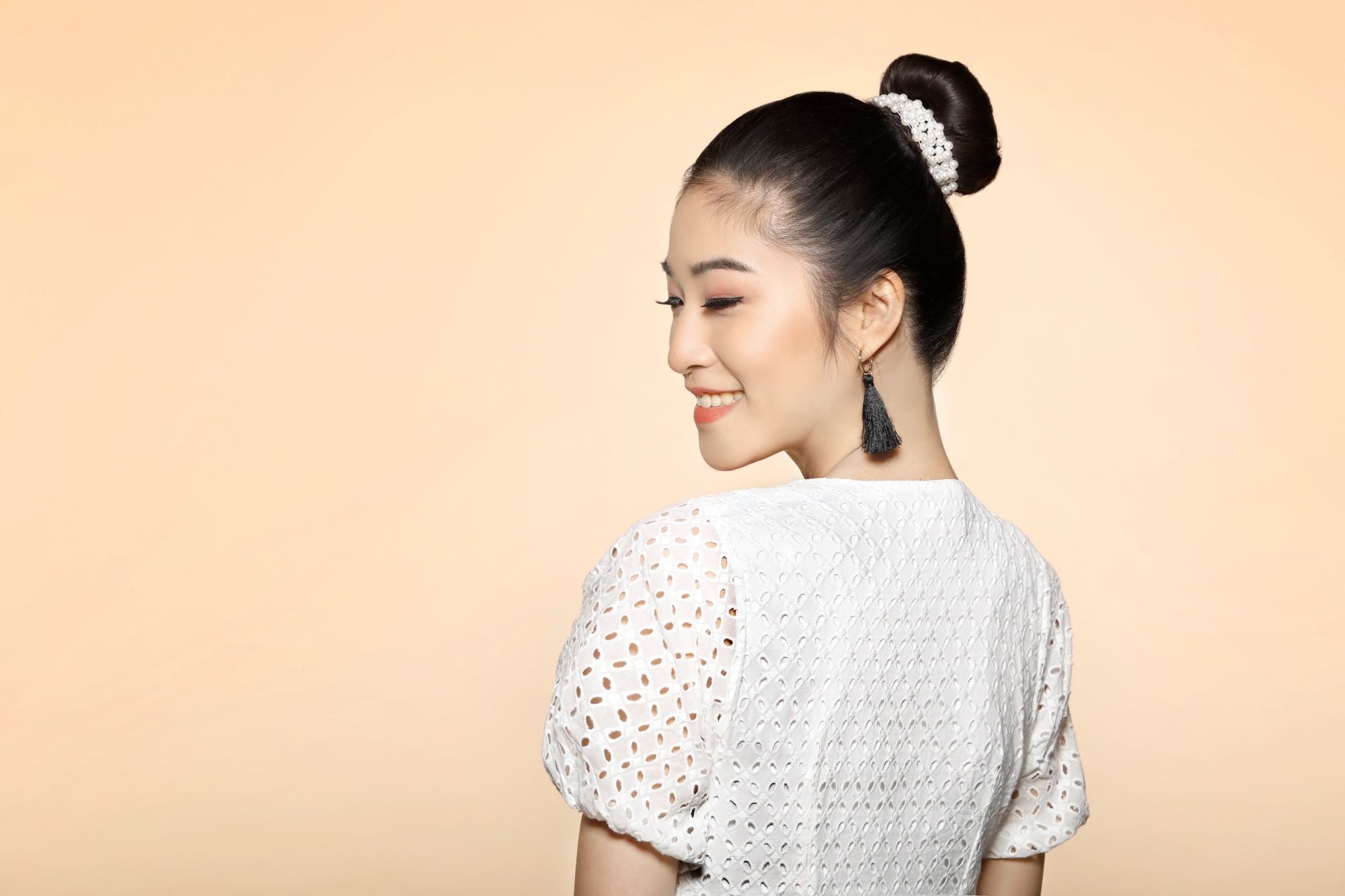 Valentine's Day: Asian woman with a ballerina bun wearing a white dress
