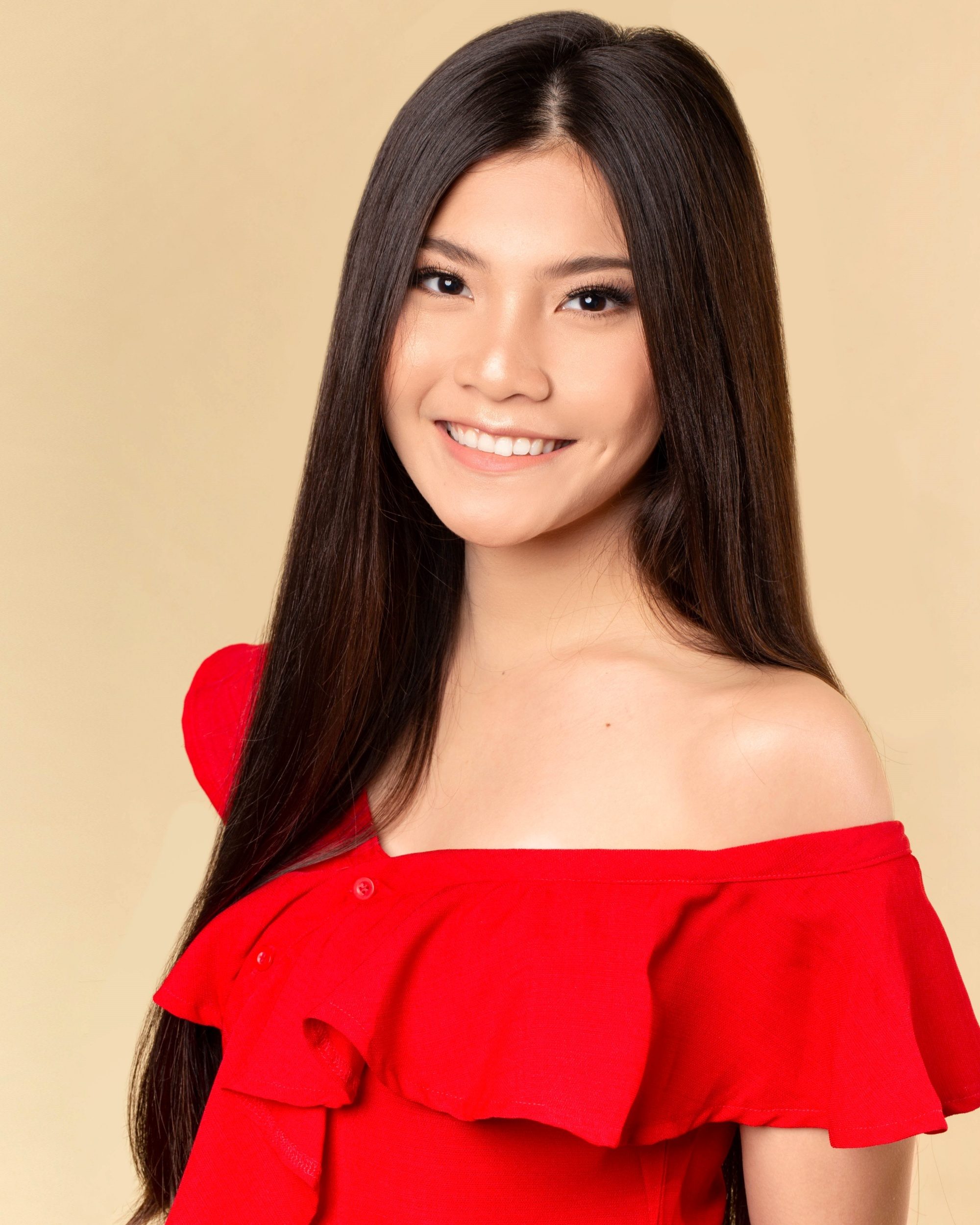 How to treat dry and damaged hair: Asian woman with long straight hair wearing a red top
