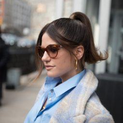 New York Fashion Week Street Style: Girl is wearing sunglasses and dangling earrings