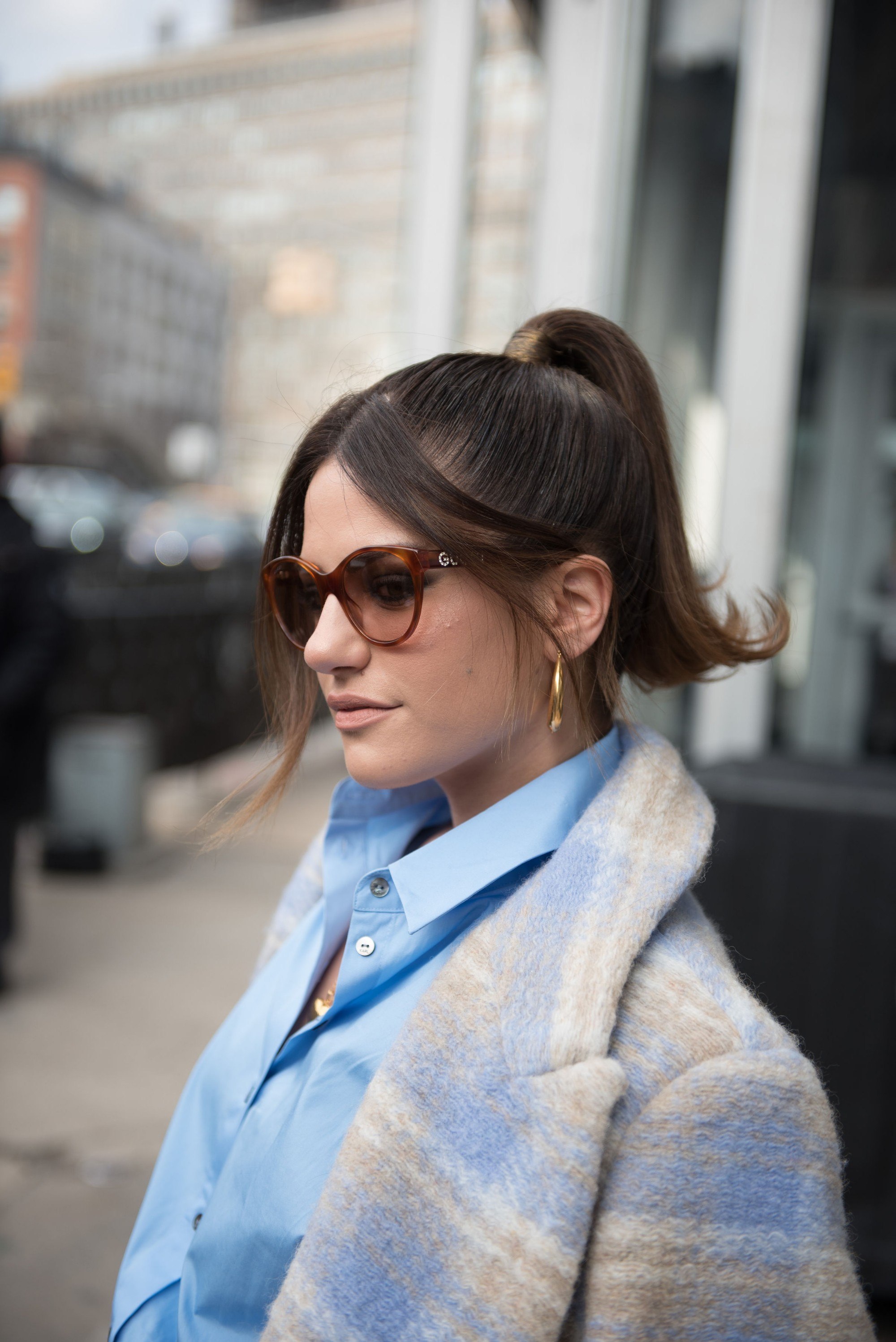 New New York Fashion Week Street Style: Girl is wearing sunglasses and dangling earrings
