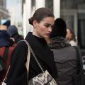 New York Fashion Week Street Style: Girl is wearing a black dress with a shoulder bag.