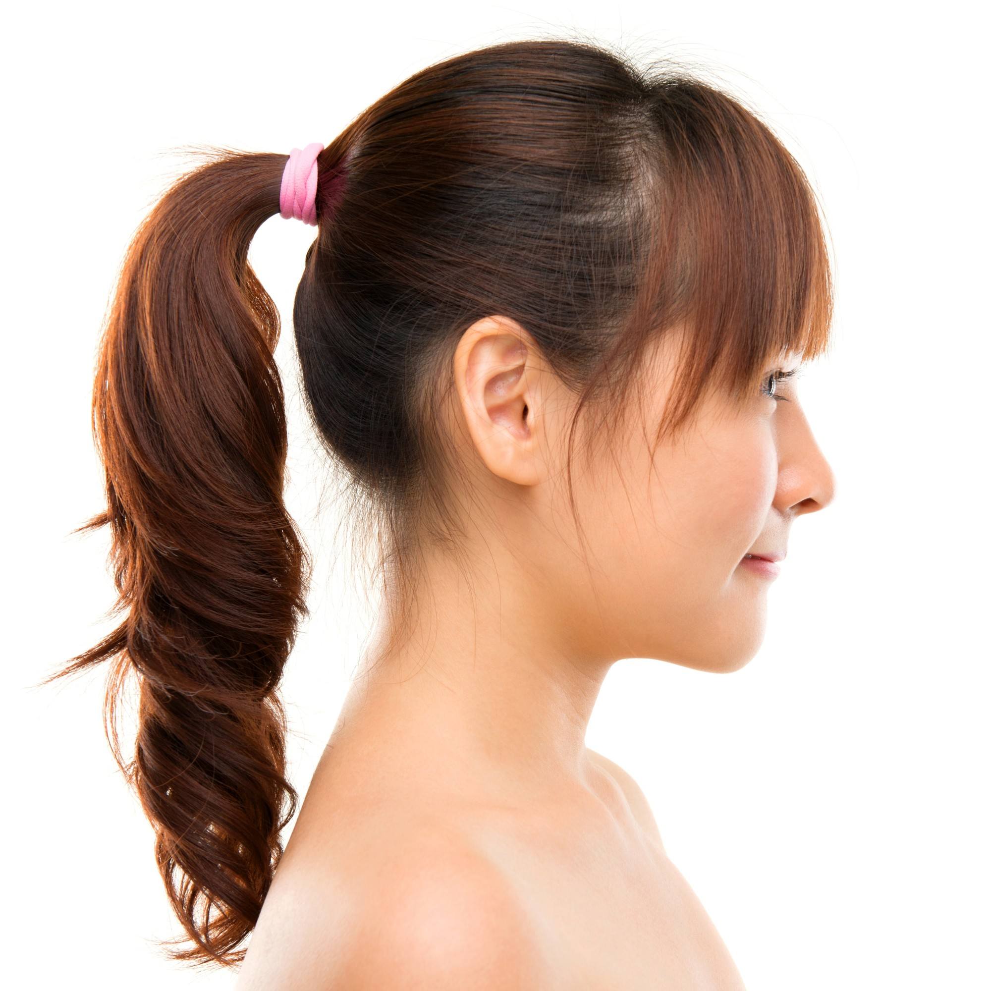 how to curl hair: girl is facing sideways to show her twisted ponytail
