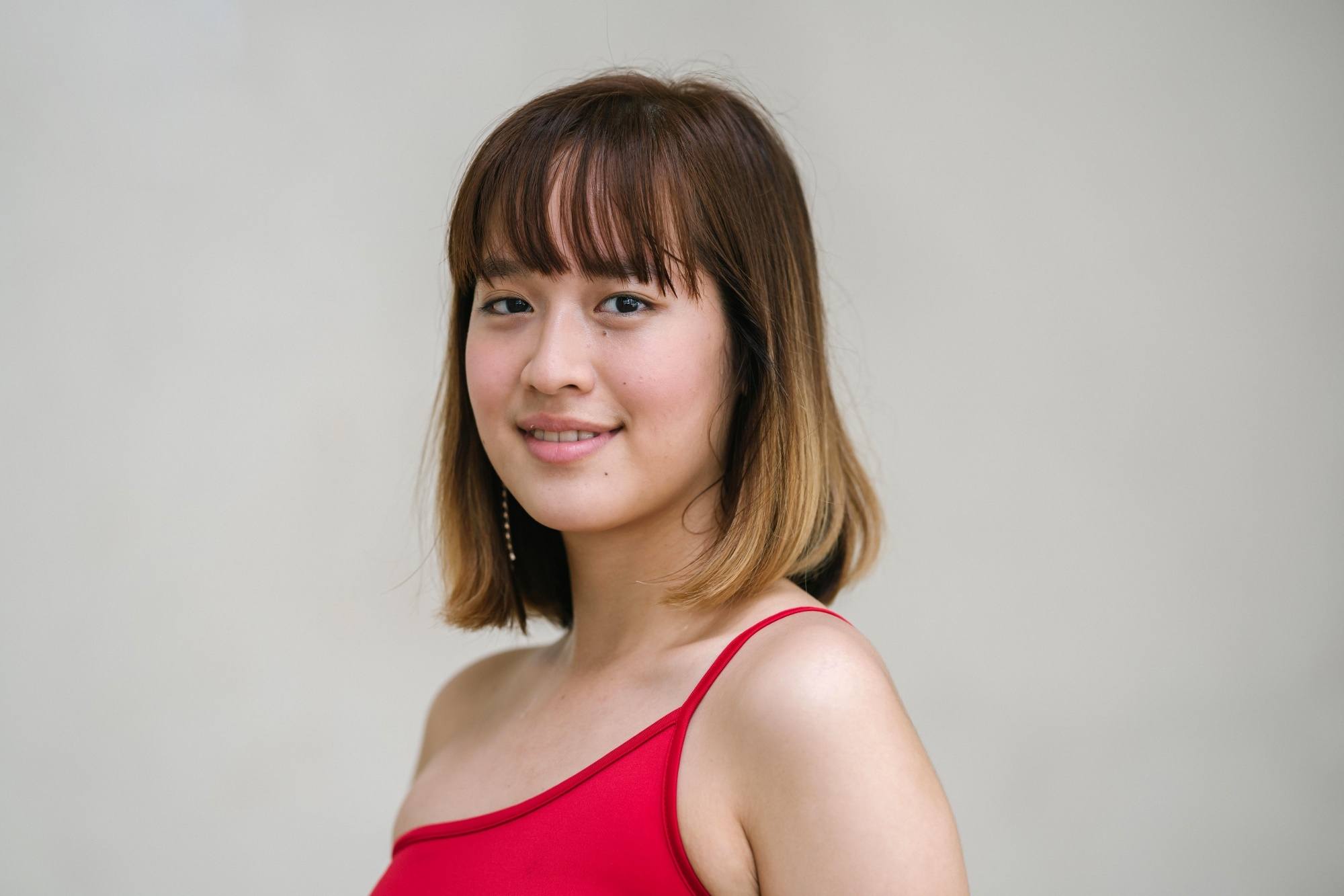 Asian woman with a lob and wispy bangs