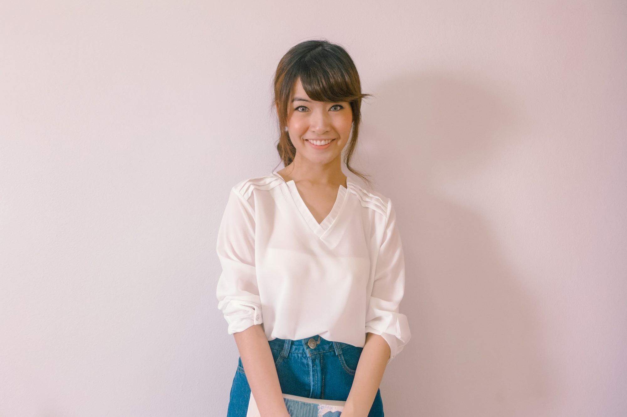Asian woman with side-swept bangs similing
