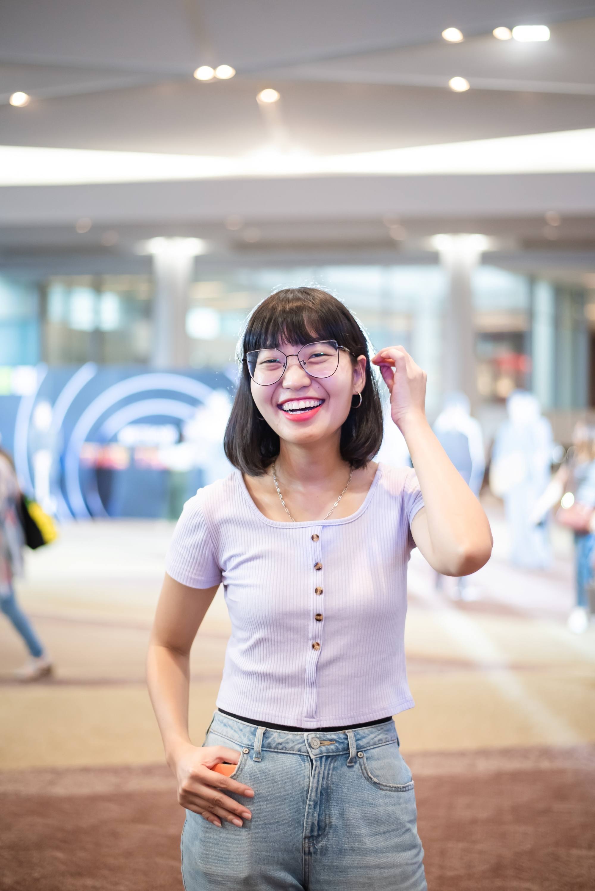 Asian woman with short hair and blunt bangs wearing eyeglasses