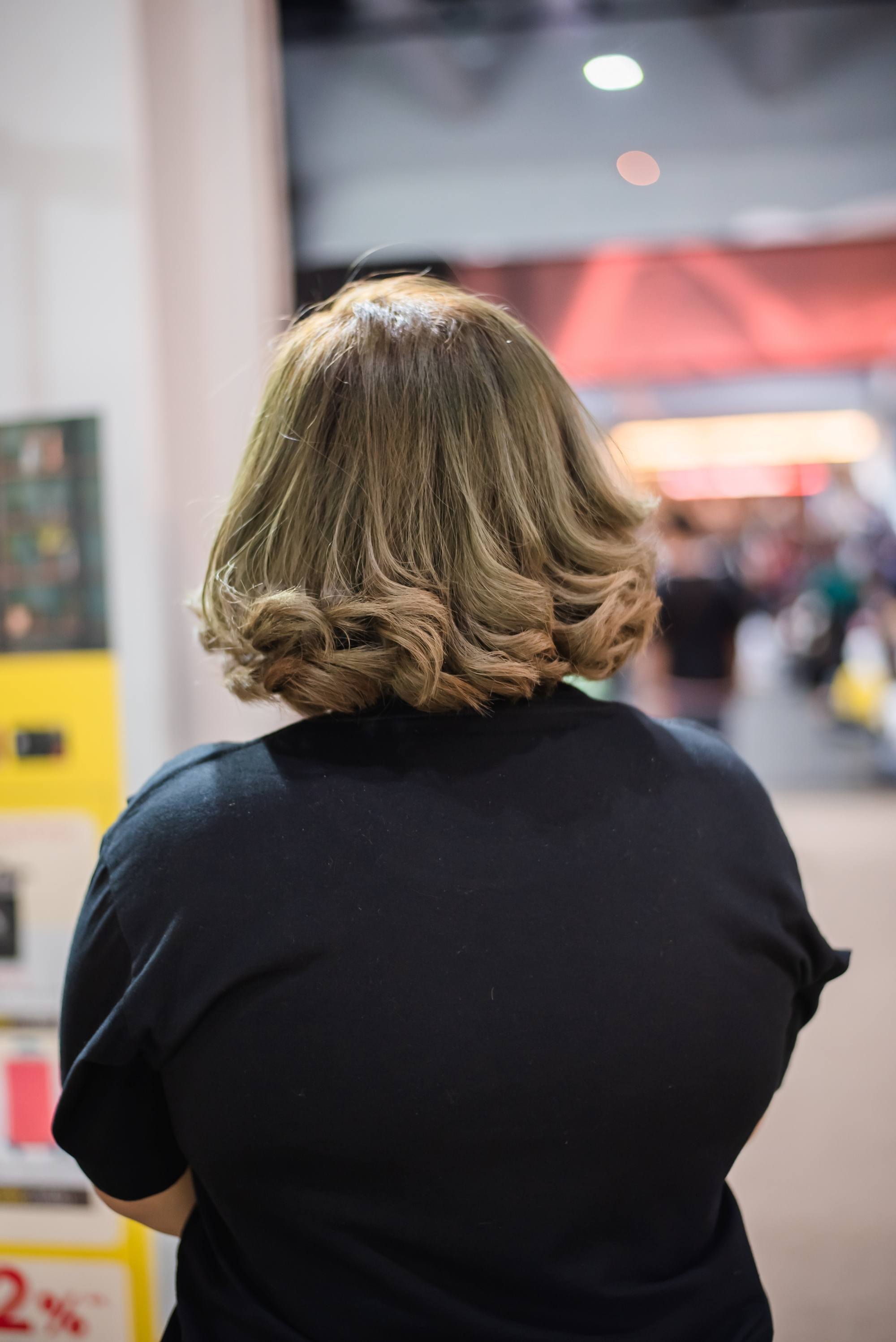 Back shot of an Asian woman with ash brown balayage short hair
