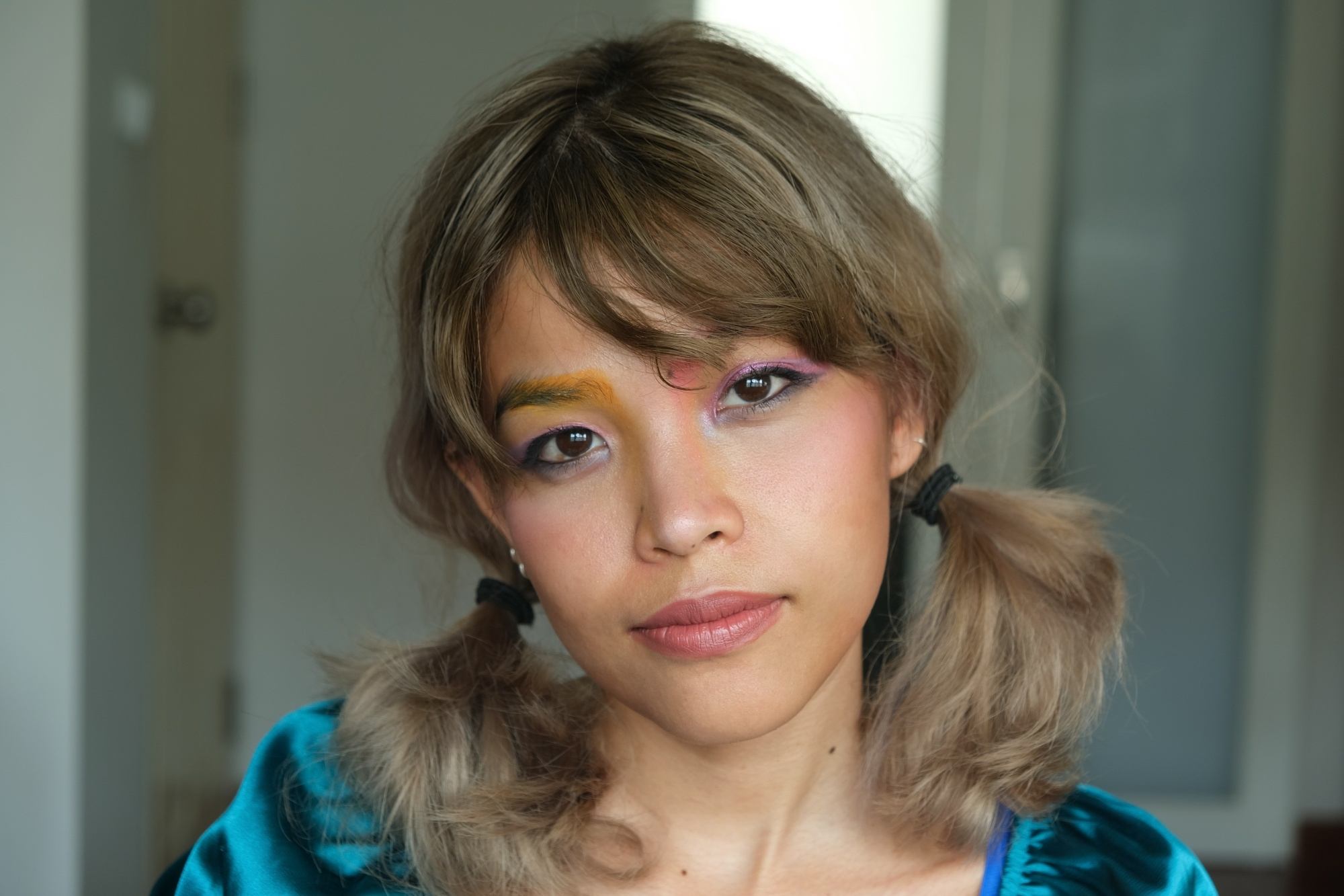 Asian woman with bangs and hair in low pigtails