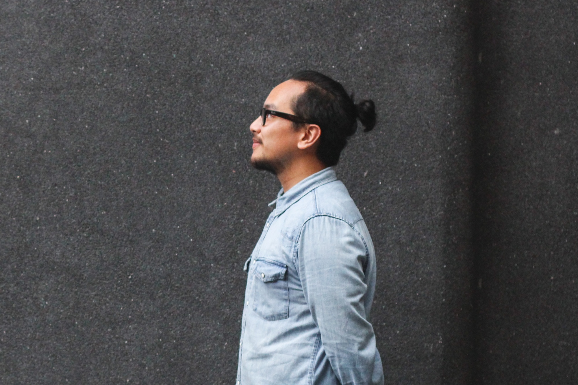 Side view of an Asian man with a man ponytail
