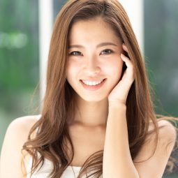 Asian woman with long dark brown hair smiling