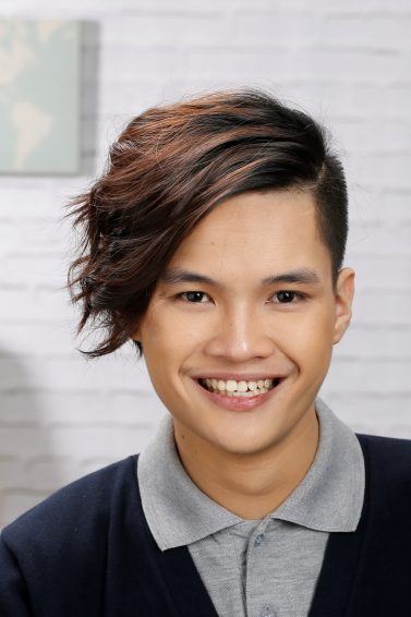 Asian man with messy hairstyle smiling