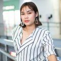 Asian woman with a short hairstyle for round face wearing a striped blouse