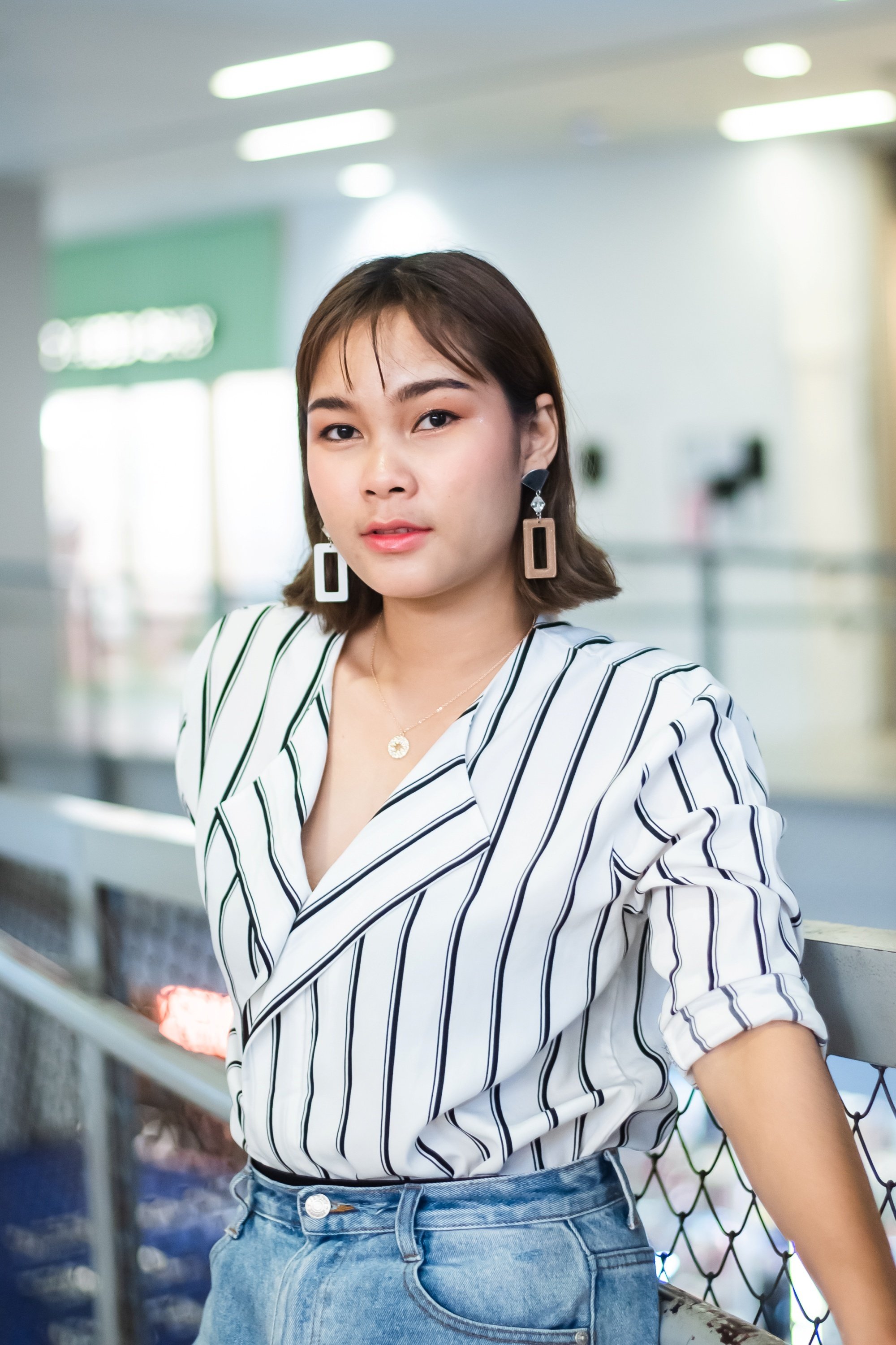 Asian woman with a short hairstyle for round face wearing a striped blouse