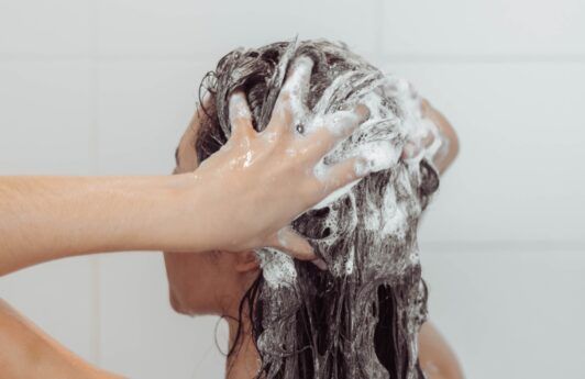 Asian woman washing her thin hair