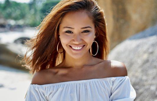 Asian woman with morena skin smiling