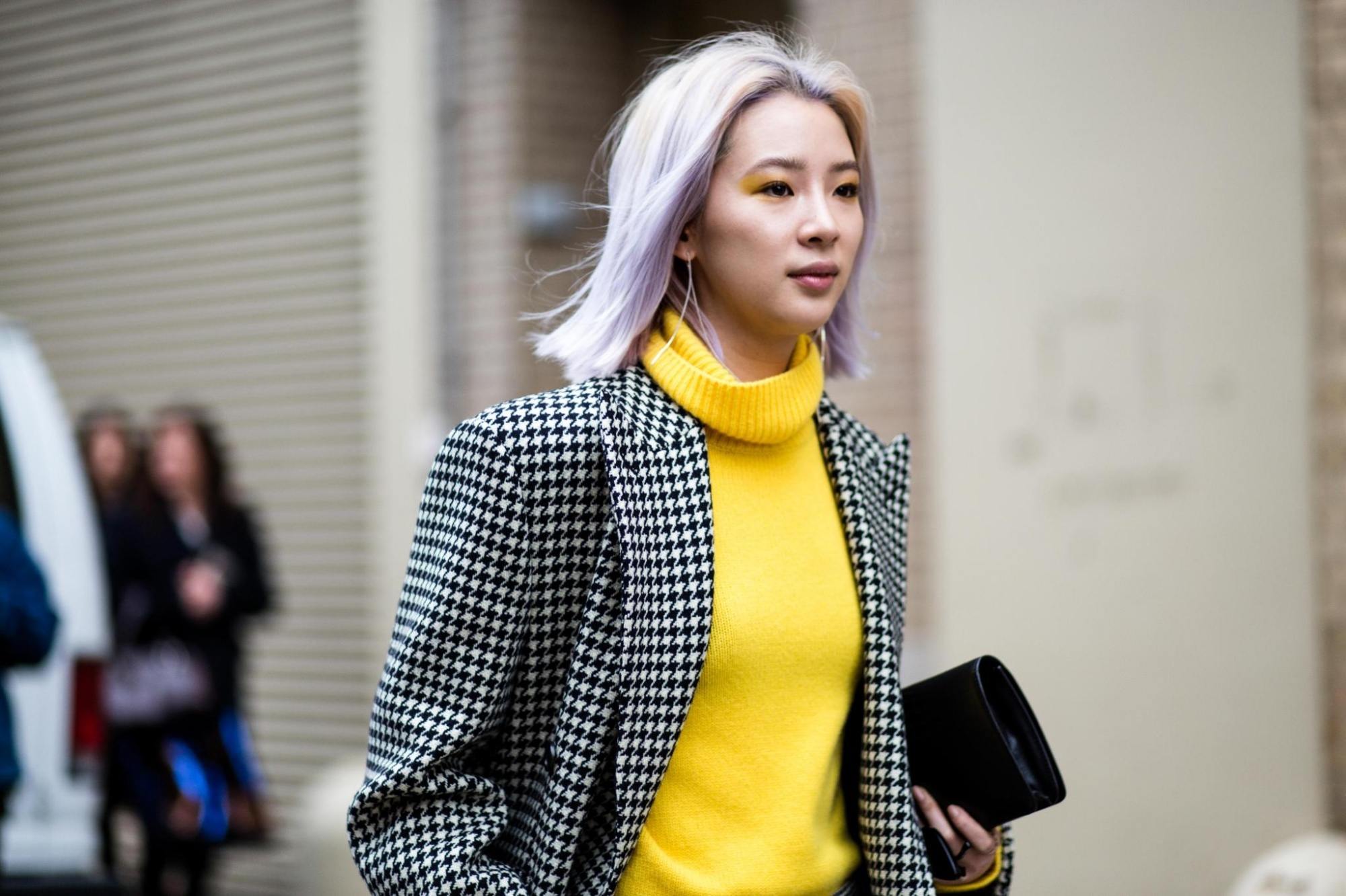 Asian woman with bleached hair walking on the street