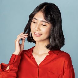 Asian woman with Korean short hair wearing a red top
