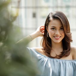 Nature-powered conditioner: Asian woman with beautiful hair wearing a blue dress