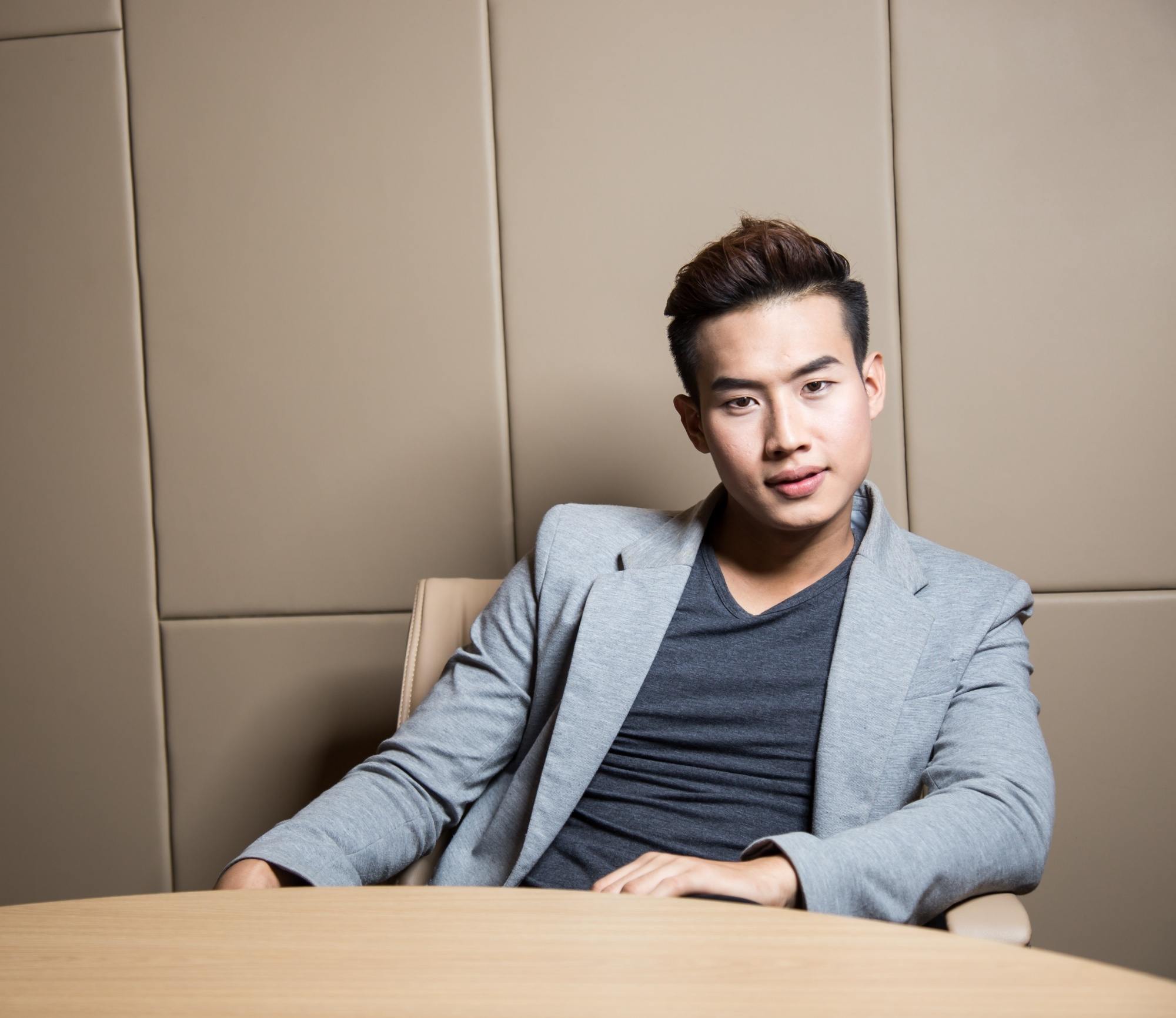 Asian man wearing a suit with a disconnected undercut hair