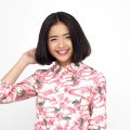 Asian woman with short hair for round face wearing a pink printed blouse
