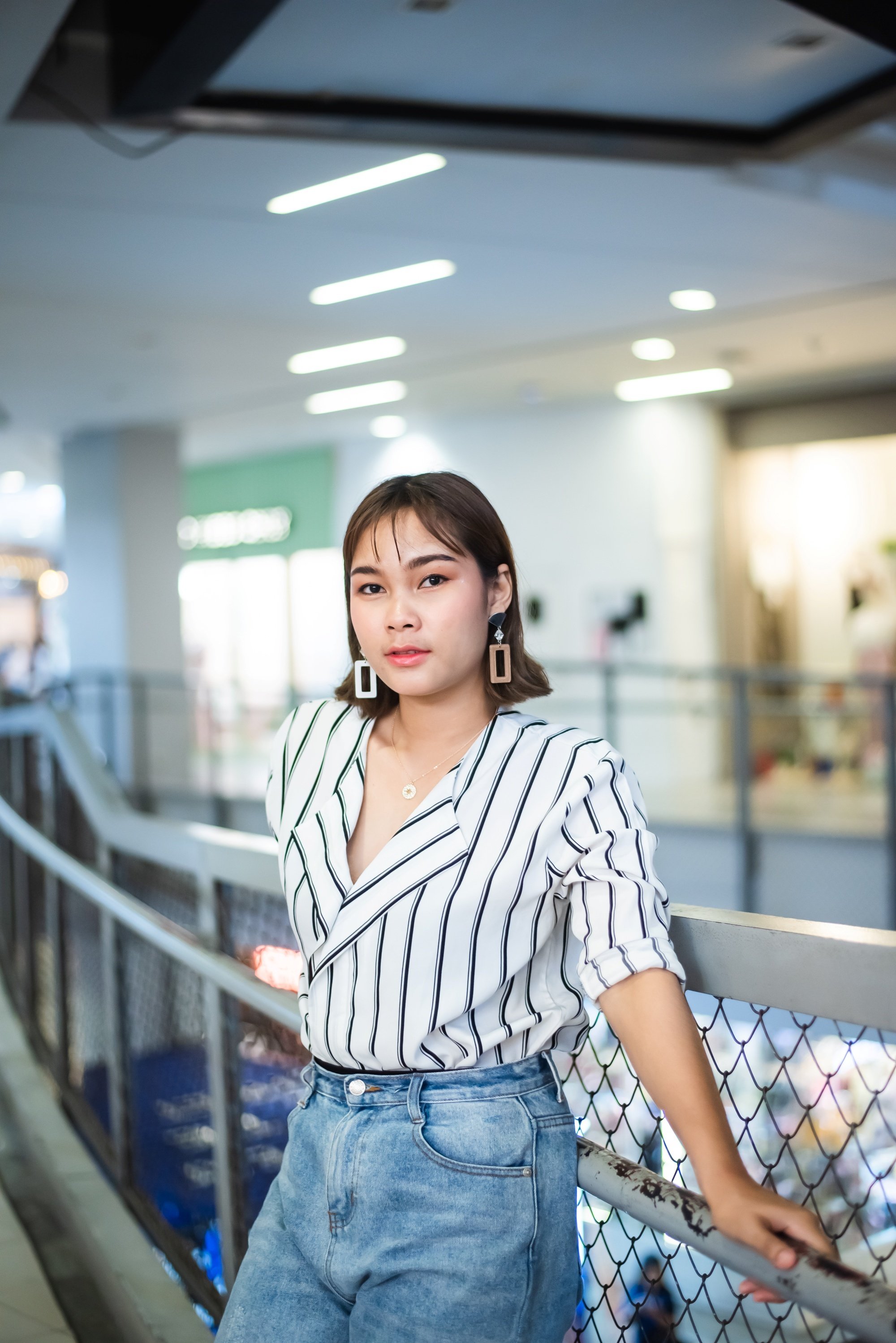 Asian woman with short hair wearing a striped blouse