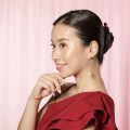 Asian woman with an updo waring a red dress