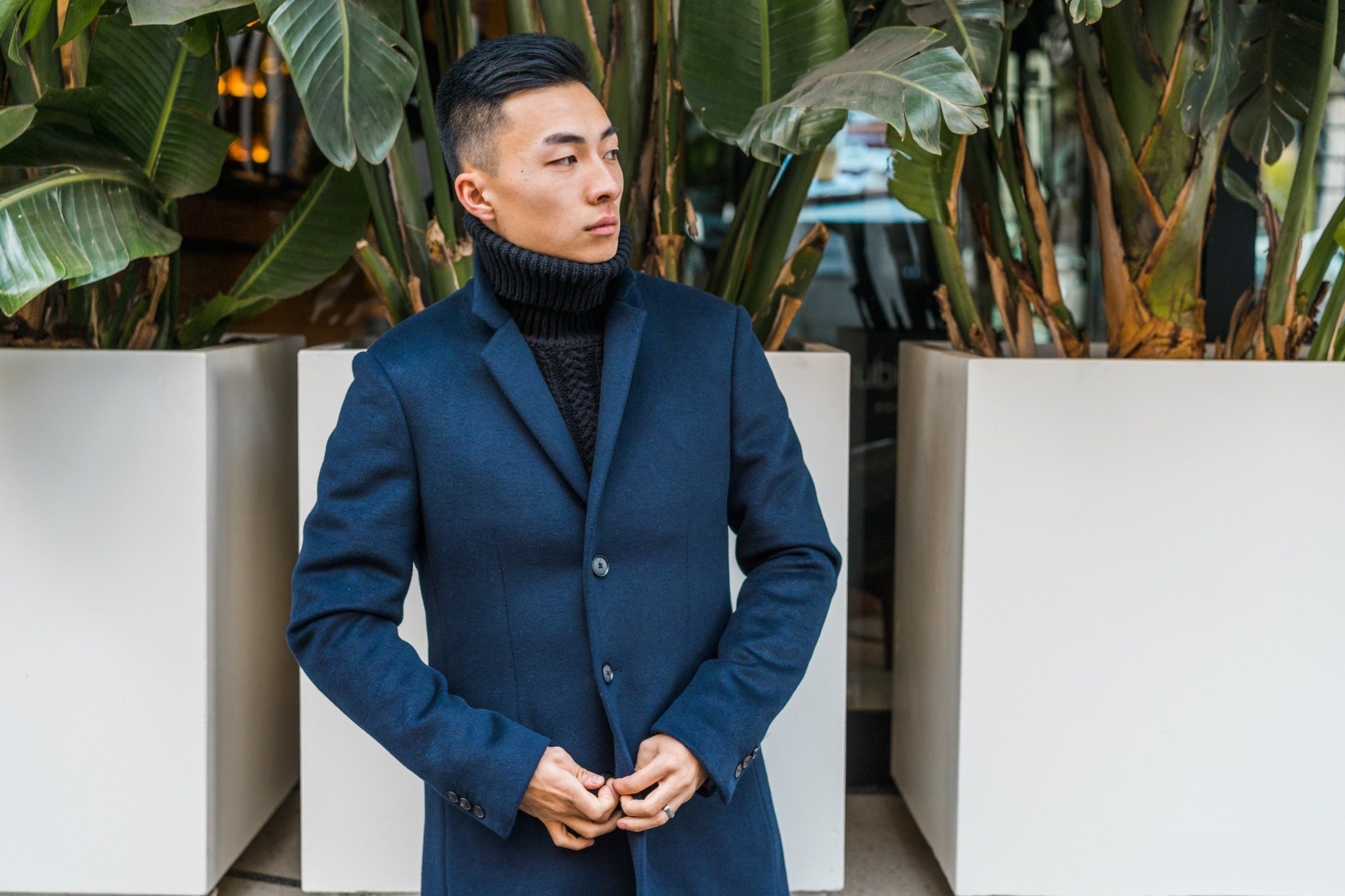 Asian man with short haircut wearing a coat