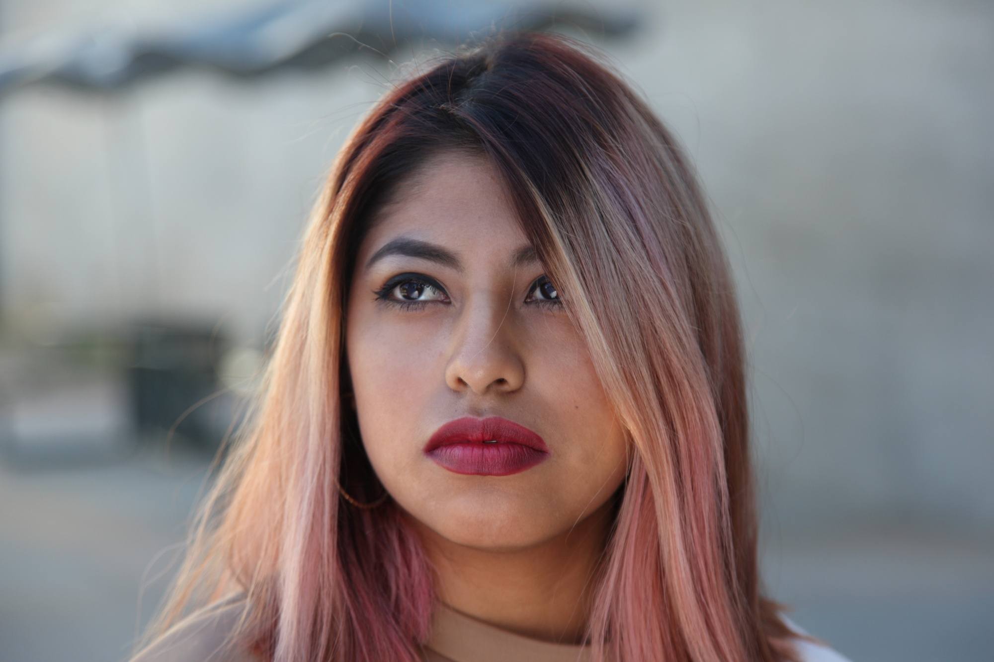 Asian woman with balayage strawberry blonde hair