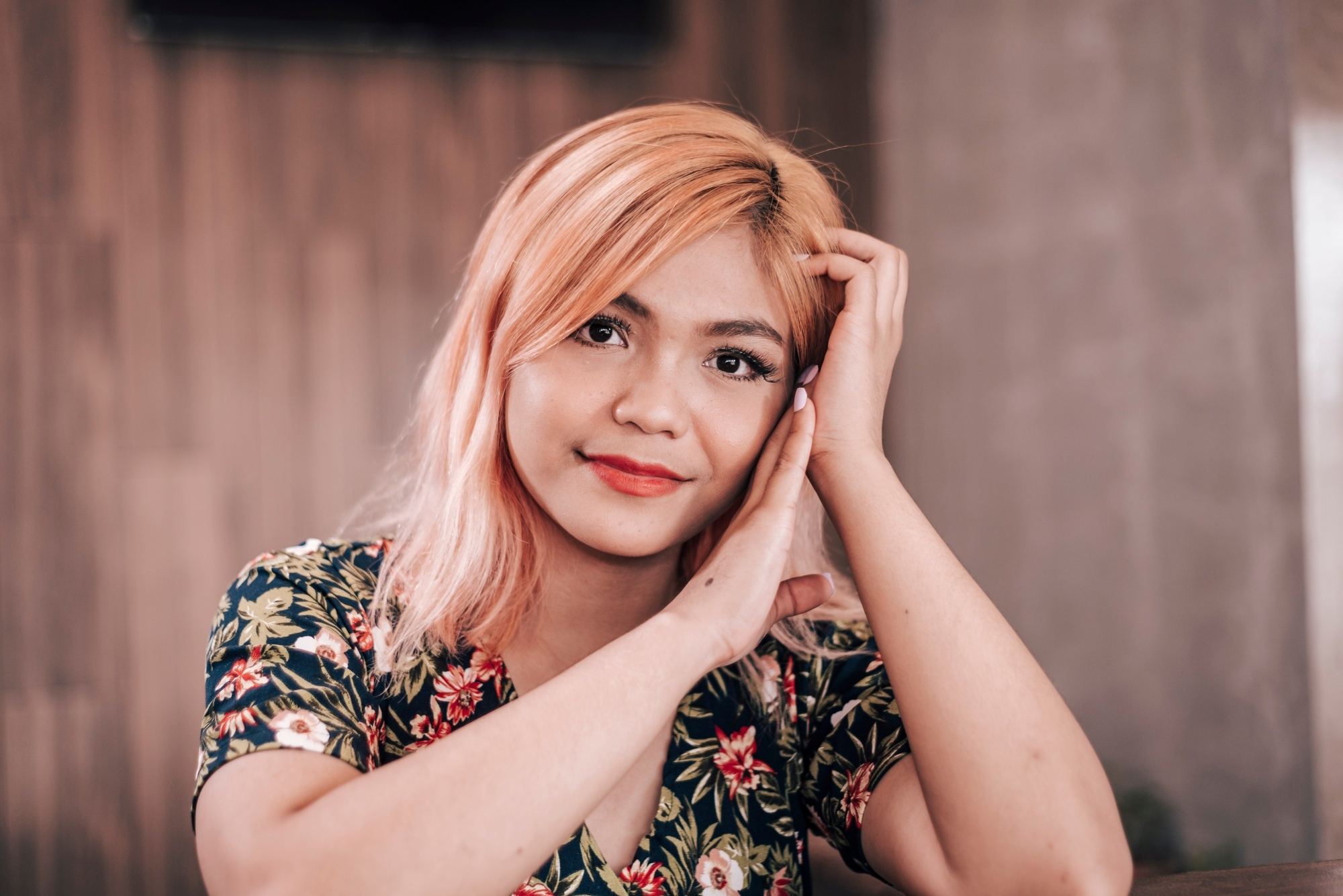 Asian woman with strawberry blonde hair