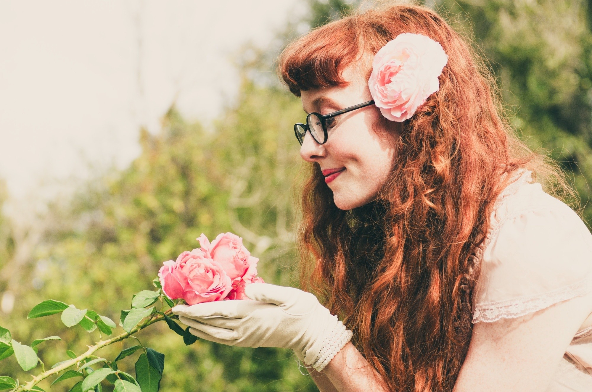 Woman with long curly hair wearing eyeglasses