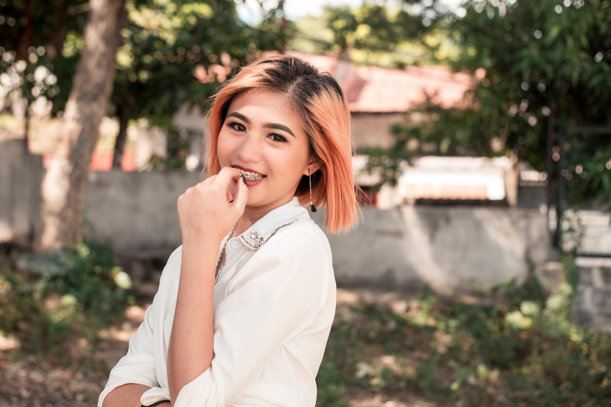 Asian woman with short strawberry blonde hair