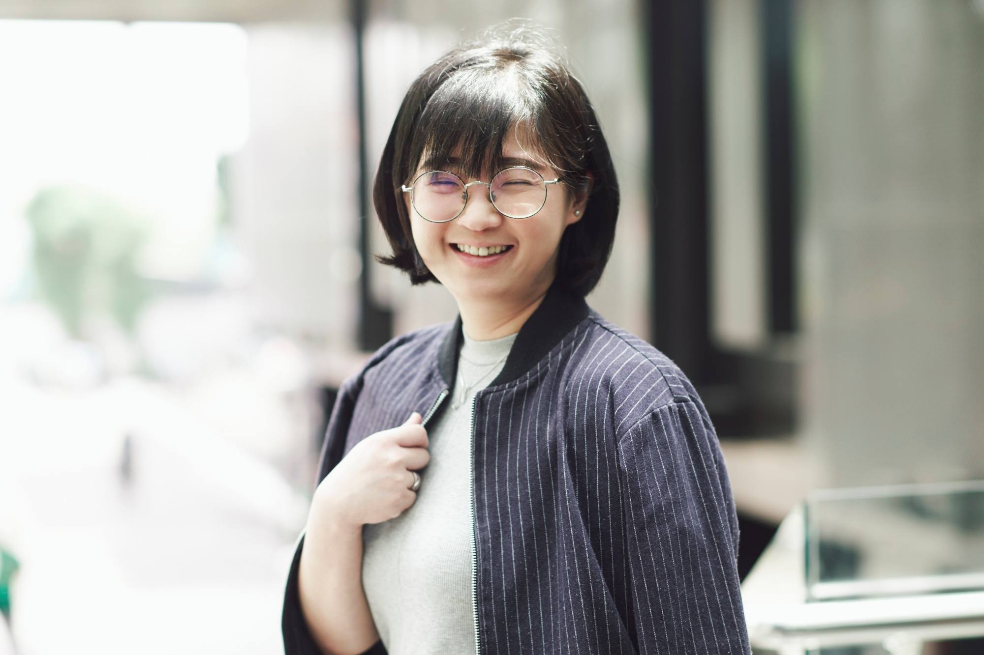 Asian woman with short hair wearing eyeglasses