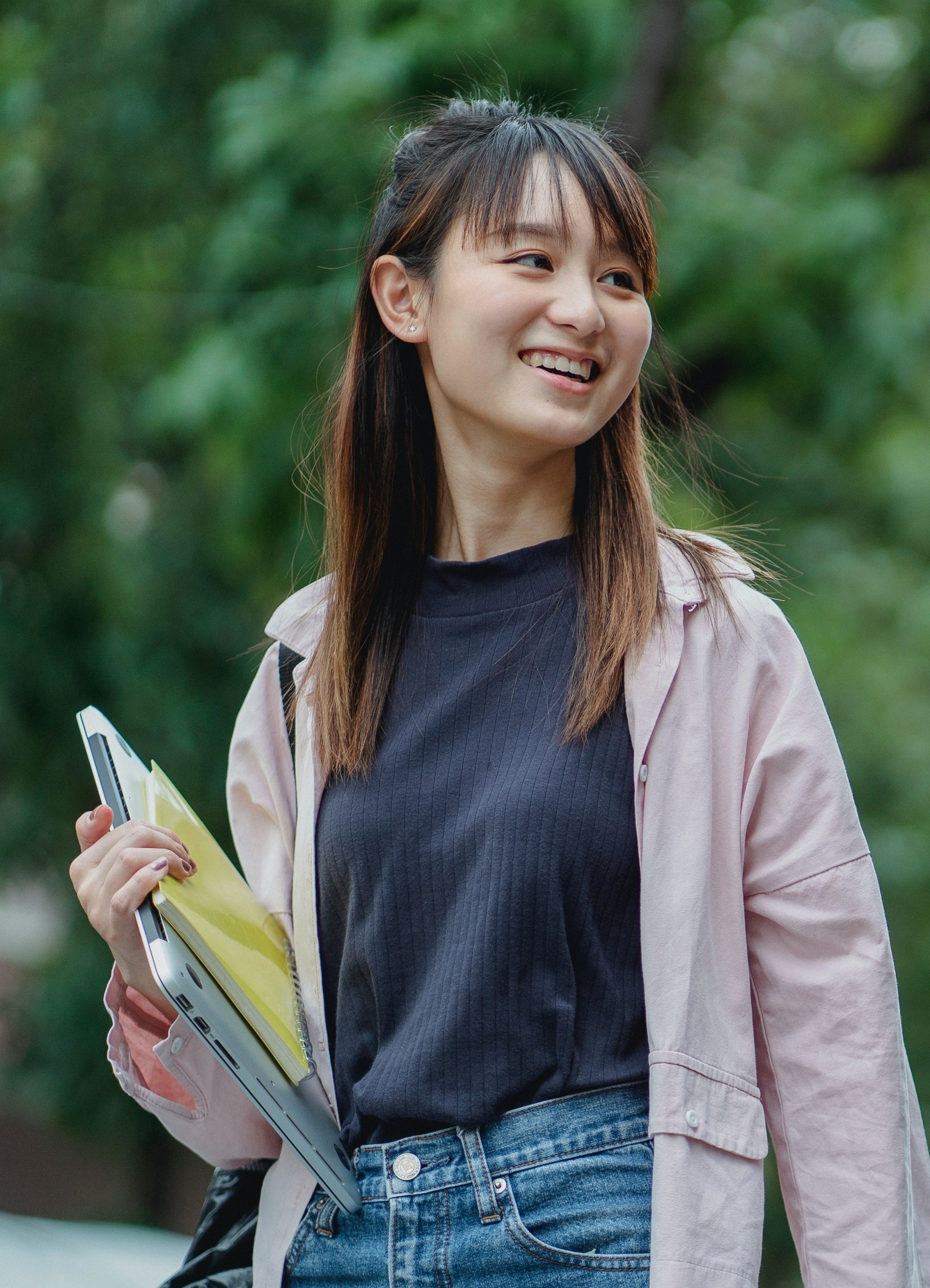 Asian woman with long hair in a half updo