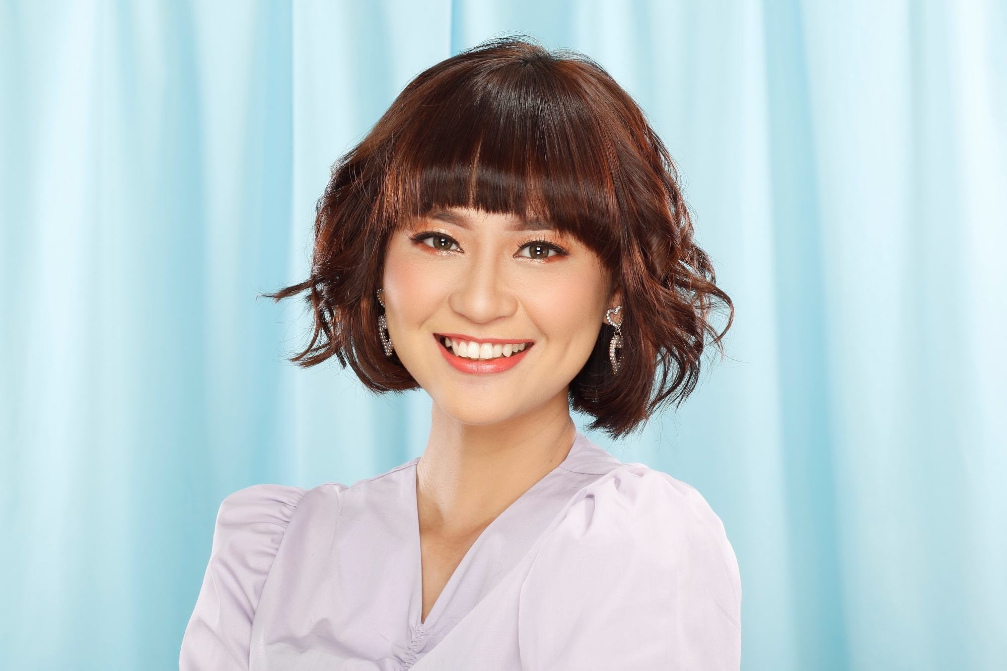 Asian woman with a textured bob and bangs for round face