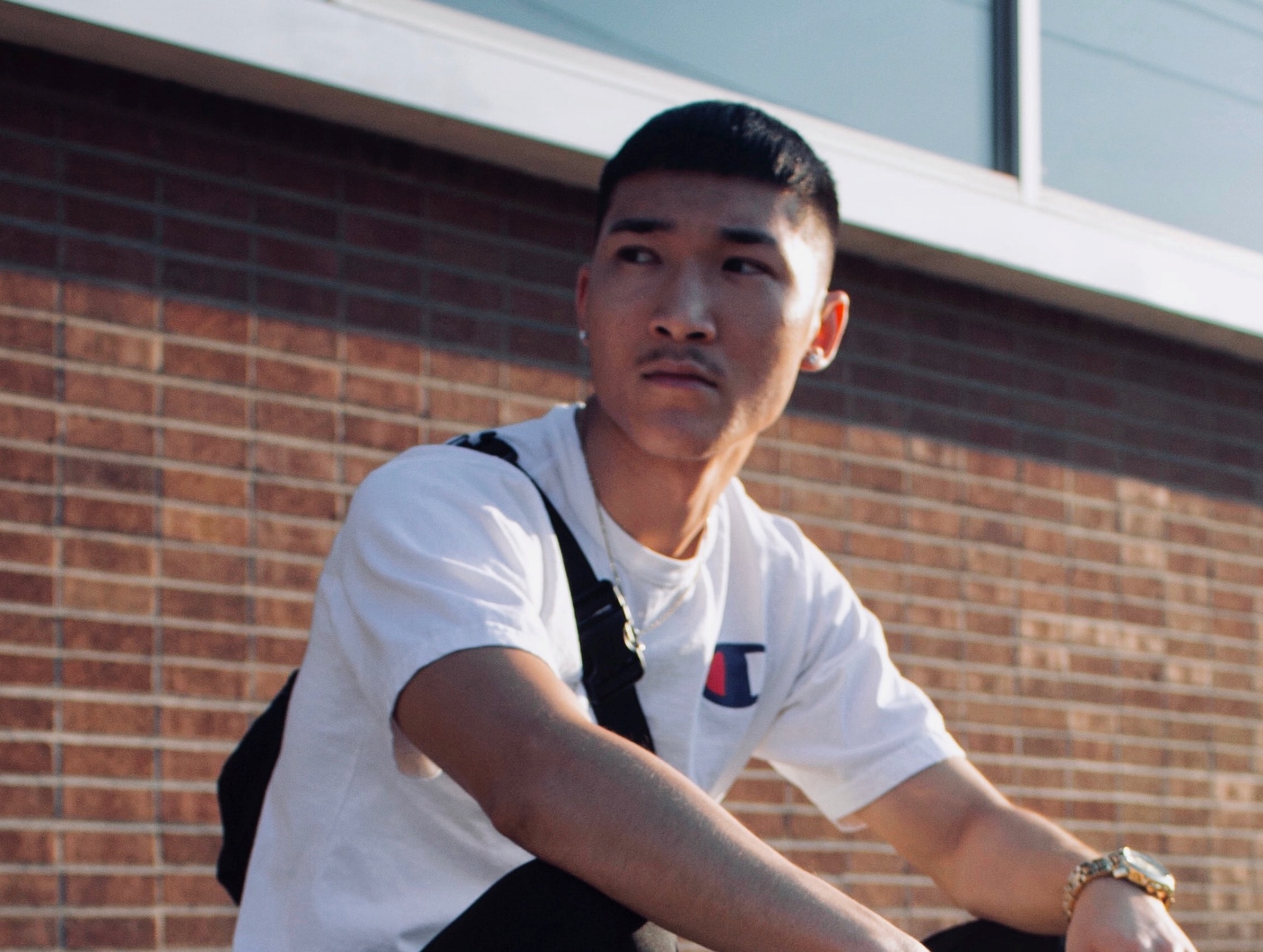 Asian with a caesar haircut wearing a white shirt