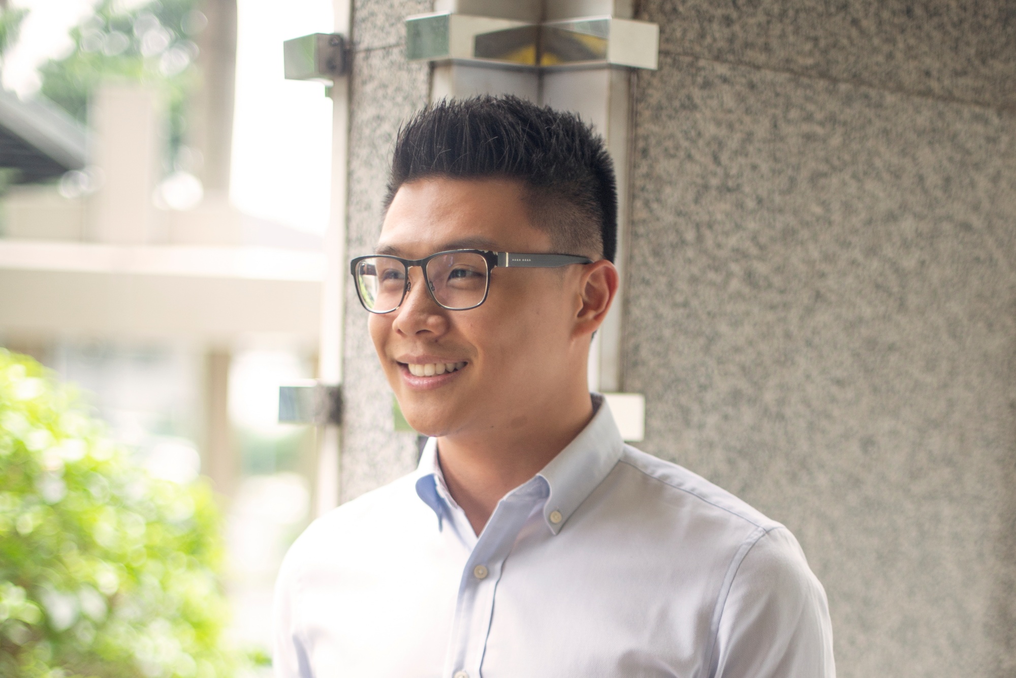 Asian with brushed up hair and undercut wearing eyeglasses