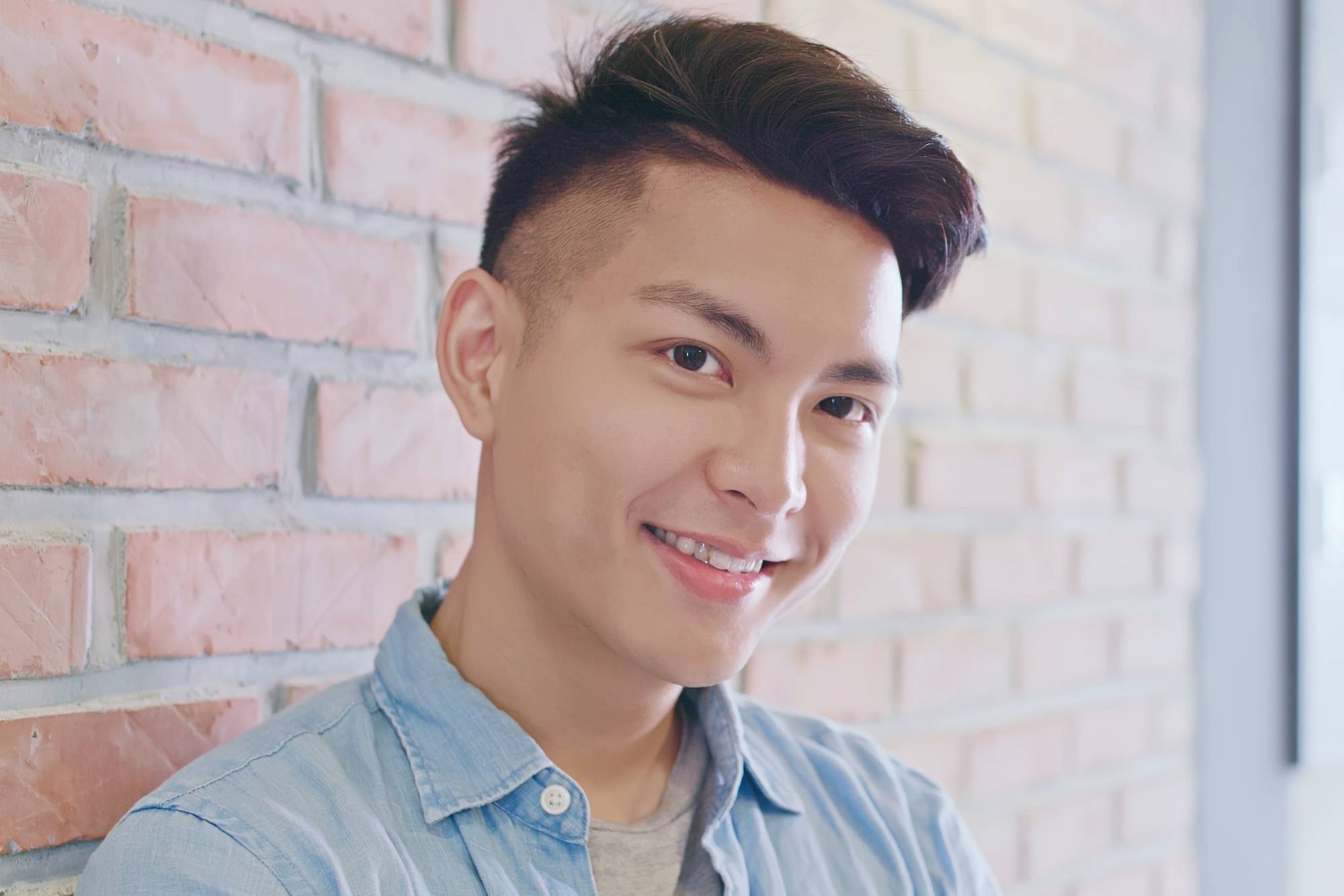Asian man with clean cut hair smiling