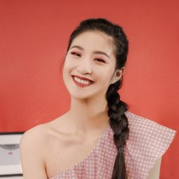 Asian woman with a French braid wearing a red top