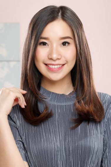 Hair treatment: Asian woman with long beautiful hair smiling