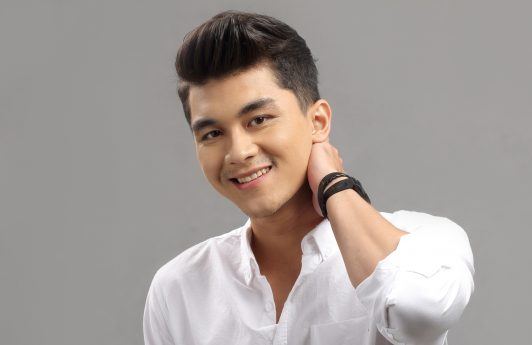 Men's shampoo sale: Asian man wearing a white polo smiling