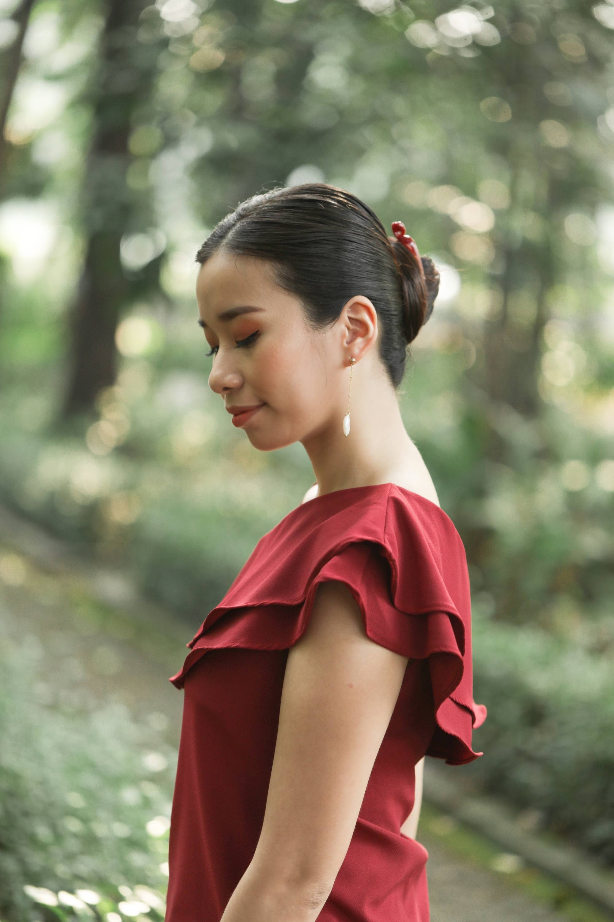 Side view of an Asian woman with a banana clip bun for long hair